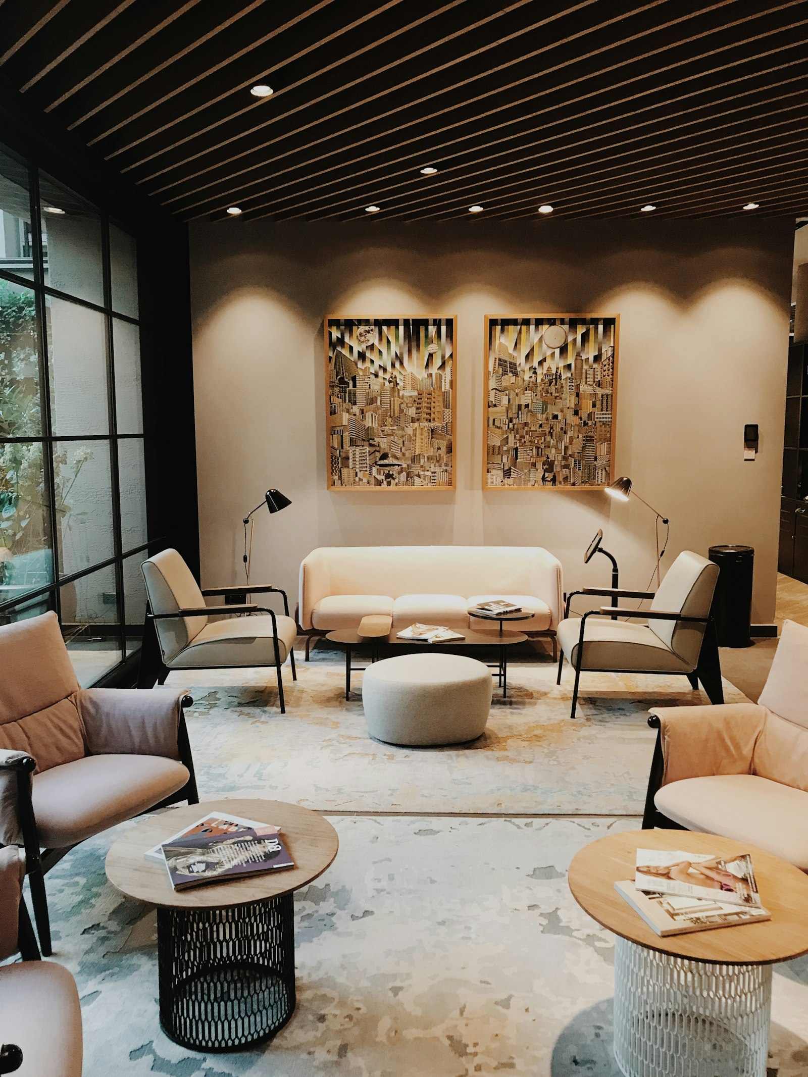 Lounge seating area with armchairs and a bespoke abstract-patterned New Zealand wool rug under warm downlighting